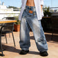 Damjeans med asymmetrisk midja och vida ben